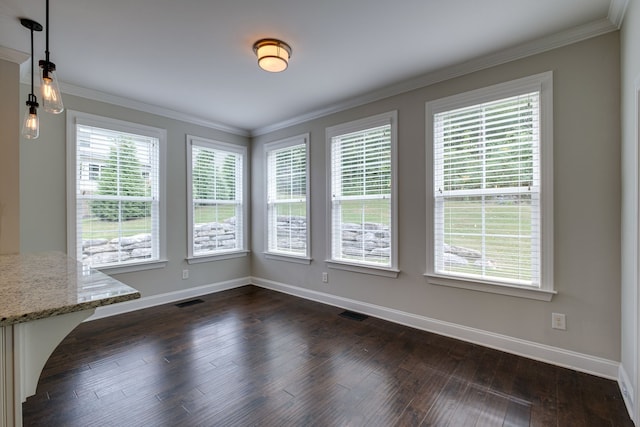 unfurnished dining area with crown molding, dark wood-type flooring, and a wealth of natural light