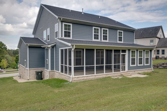 back of house with a lawn and a sunroom