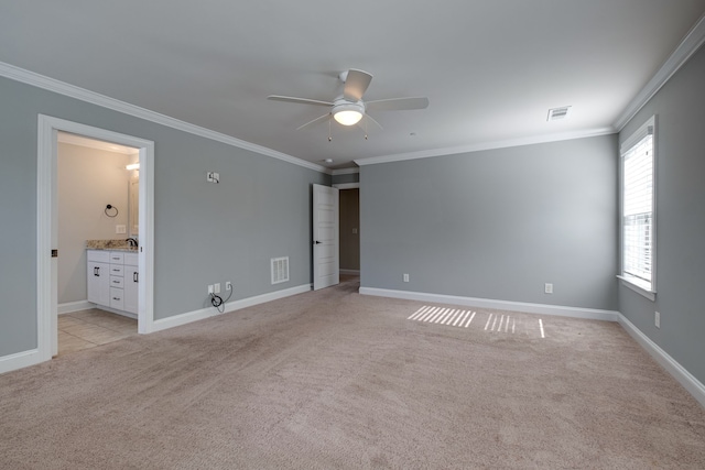 spare room featuring ornamental molding, sink, ceiling fan, and light colored carpet