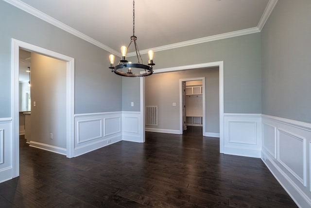 unfurnished dining area featuring dark hardwood / wood-style floors, ornamental molding, and a chandelier