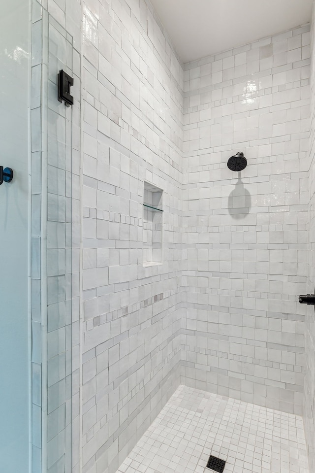 bathroom with tiled shower