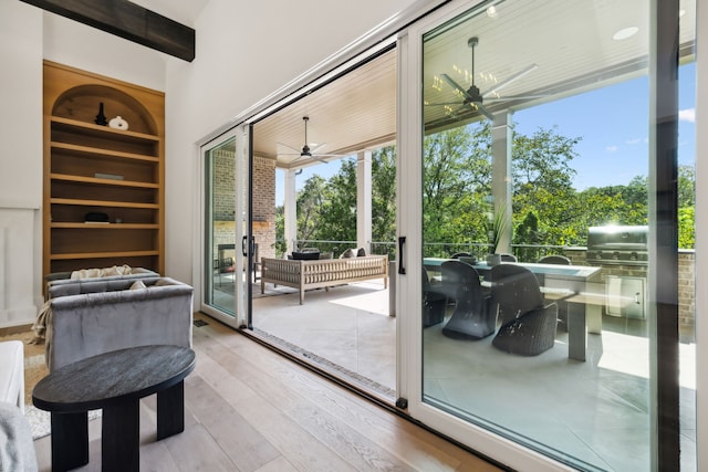 entryway with hardwood / wood-style floors, built in features, and ceiling fan