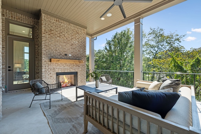 view of patio featuring an outdoor living space with a fireplace and ceiling fan