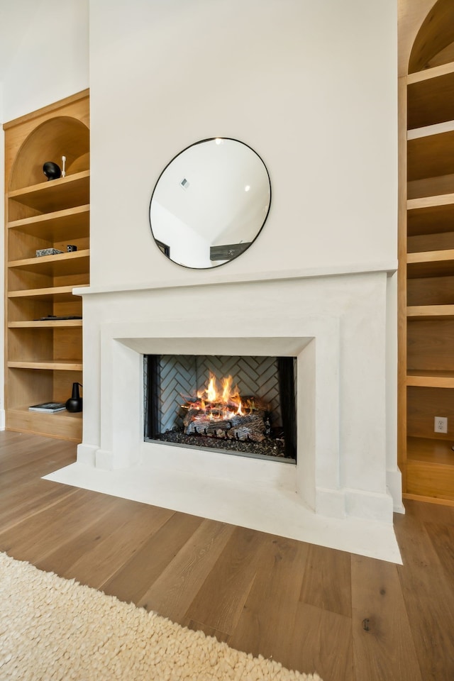 details featuring hardwood / wood-style floors and built in shelves