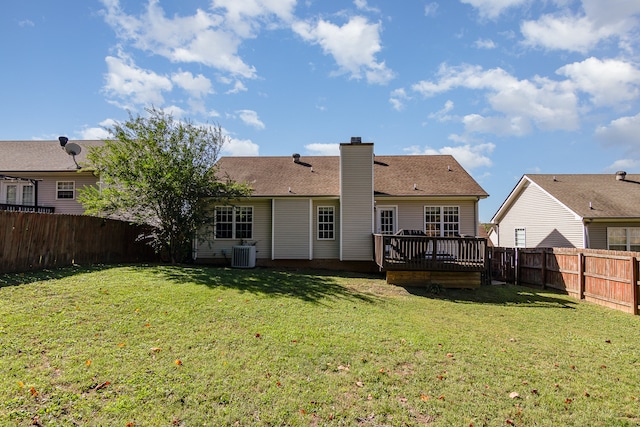 rear view of house featuring a yard, cooling unit, and a deck