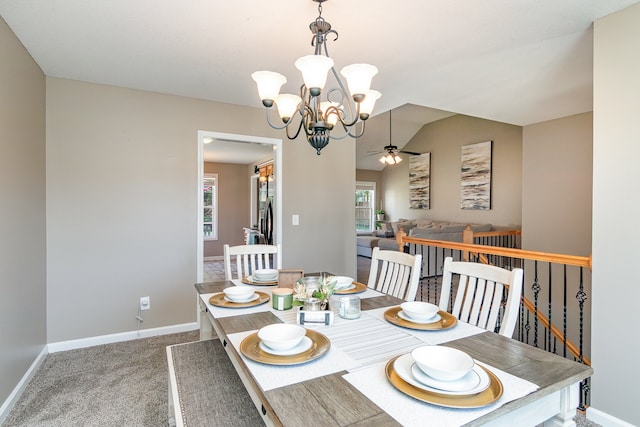 dining space with ceiling fan with notable chandelier and carpet