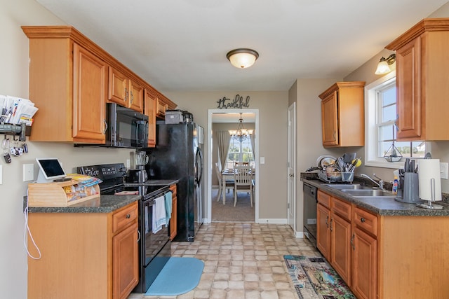 kitchen with a notable chandelier, sink, and black appliances