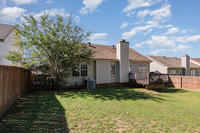 back of property featuring a yard, a wooden deck, and central air condition unit