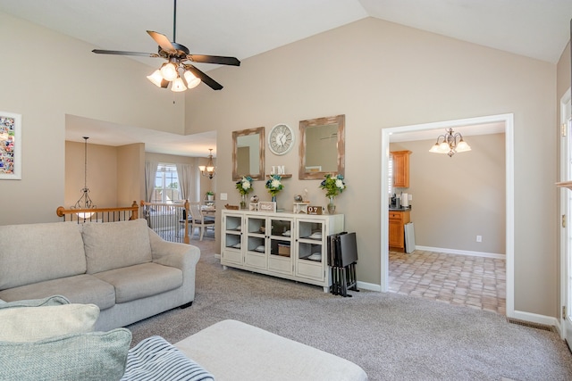 carpeted living room featuring ceiling fan with notable chandelier and high vaulted ceiling