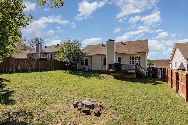 back of property featuring central AC, a lawn, and a deck