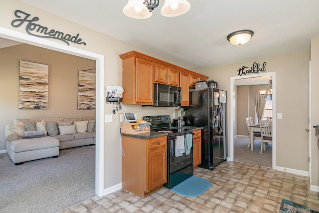 kitchen with black appliances, an inviting chandelier, and light colored carpet