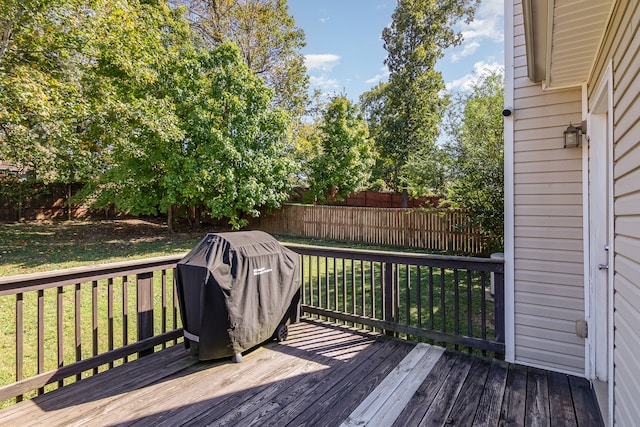 deck with a yard and area for grilling