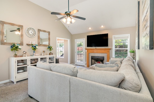 carpeted living room with a fireplace, high vaulted ceiling, and ceiling fan