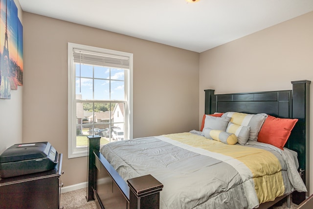 carpeted bedroom with multiple windows