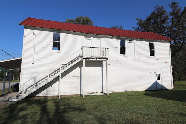 back of property featuring a lawn