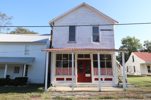 view of front of home with a front yard and covered porch