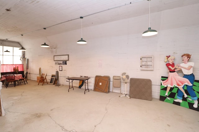 interior space with brick wall and concrete flooring