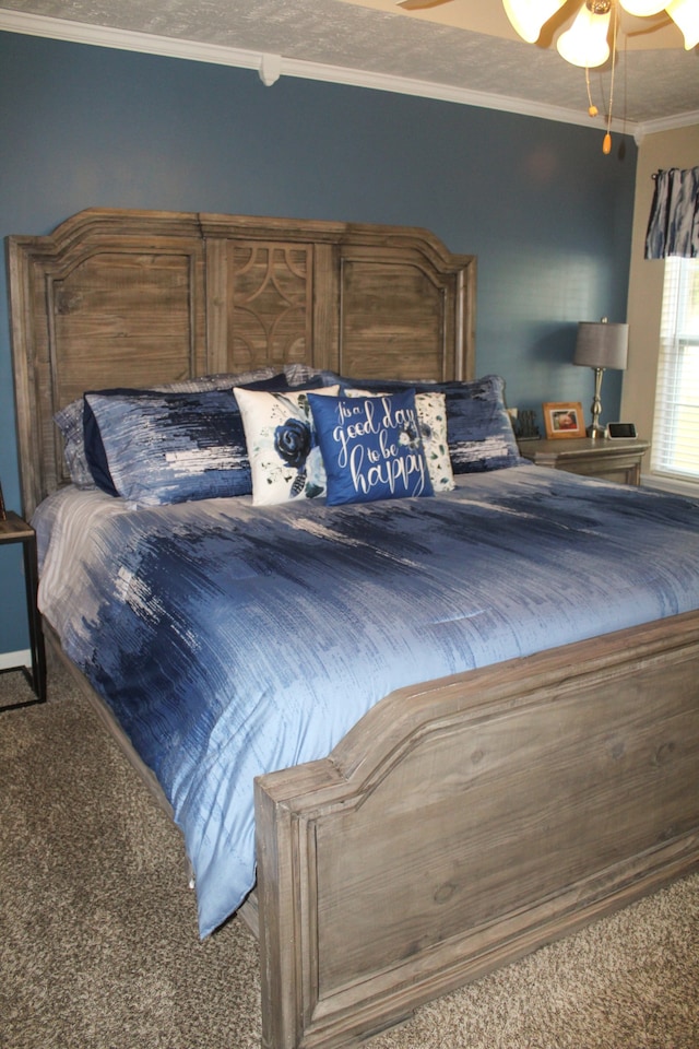 bedroom with crown molding, carpet flooring, and ceiling fan