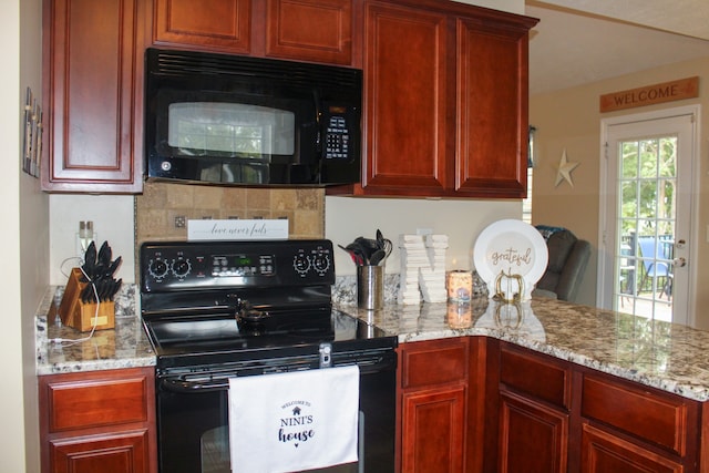 kitchen with light stone countertops and black appliances