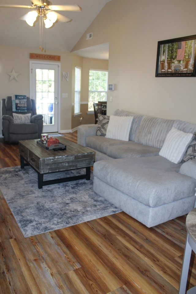 living room featuring lofted ceiling, ceiling fan, and hardwood / wood-style flooring