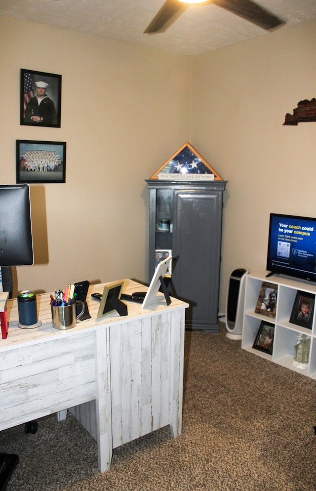 office with dark carpet, ceiling fan, and a textured ceiling