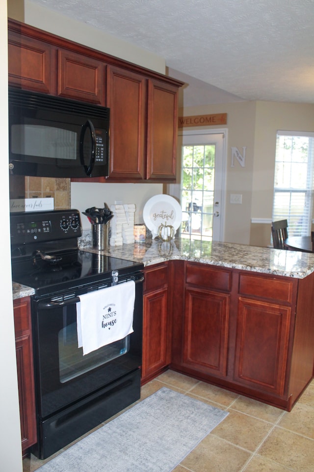 kitchen featuring a textured ceiling, black appliances, light stone countertops, and light tile patterned floors