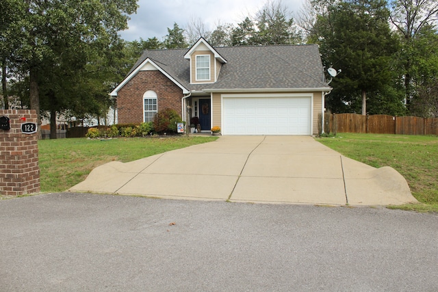 view of front of home featuring a front yard and a garage