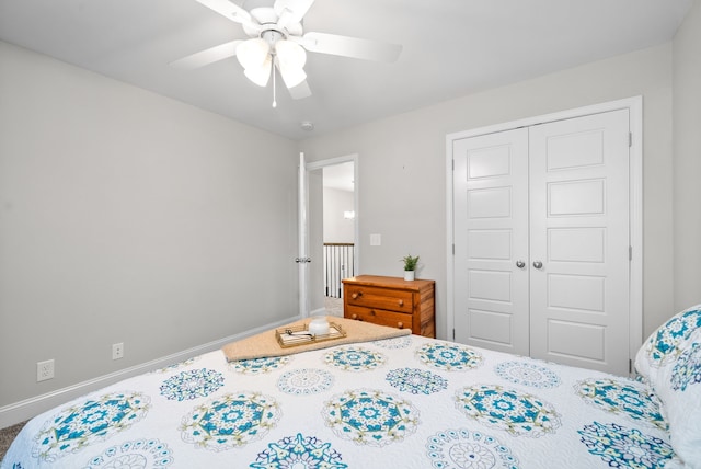 bedroom with ceiling fan, carpet floors, and a closet