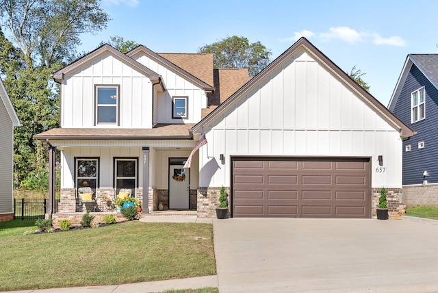 view of front facade featuring a porch, a front yard, and a garage