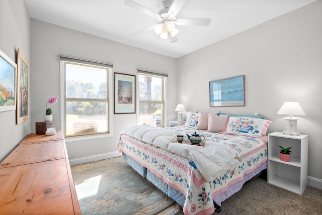 bedroom with ceiling fan and dark carpet