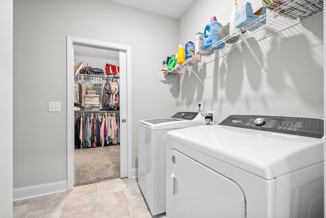 clothes washing area with washing machine and dryer and light carpet