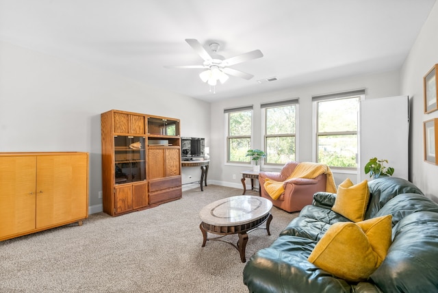 carpeted living room featuring ceiling fan