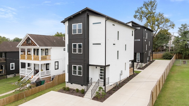 exterior space featuring a lawn and a balcony