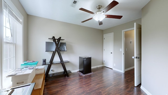 miscellaneous room with ceiling fan and dark wood-type flooring