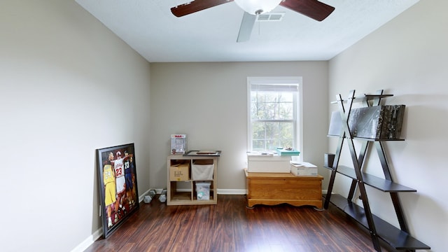 miscellaneous room with ceiling fan and dark wood-type flooring