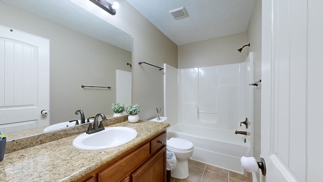 full bathroom featuring tile patterned flooring, a textured ceiling, washtub / shower combination, vanity, and toilet