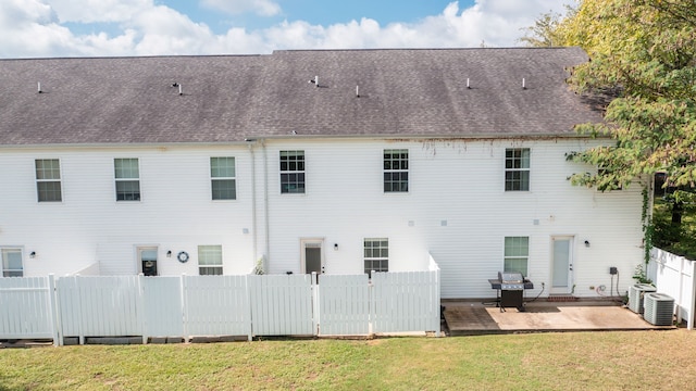 back of house with a lawn and a patio area