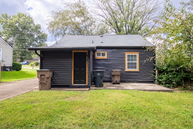 back of property featuring a yard