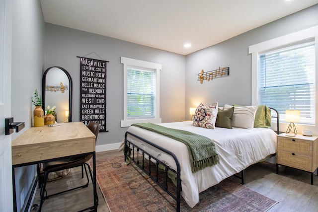 bedroom with dark hardwood / wood-style flooring