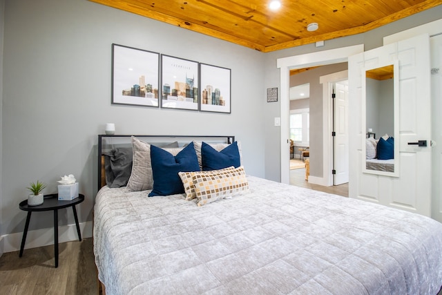 bedroom featuring wooden ceiling and hardwood / wood-style flooring