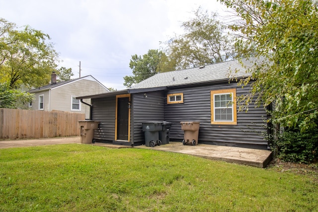 rear view of house with a yard