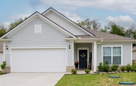 view of front of home with a front lawn and a garage