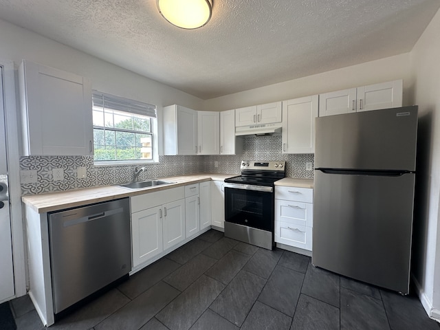 kitchen featuring white cabinets, appliances with stainless steel finishes, and sink