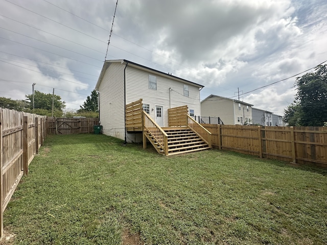 rear view of property with a lawn