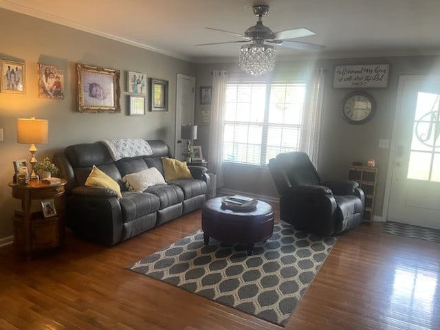 living room featuring crown molding, wood-type flooring, and ceiling fan