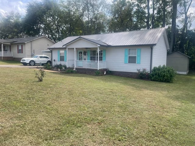 ranch-style home with a front yard and covered porch