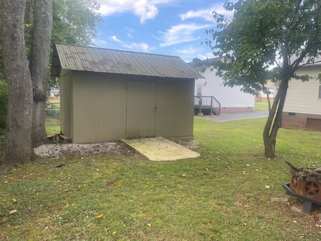 view of outbuilding featuring a lawn