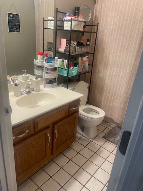 bathroom with vanity, toilet, and tile patterned floors