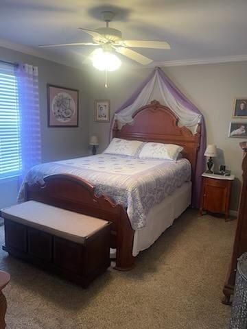 carpeted bedroom featuring ceiling fan and crown molding