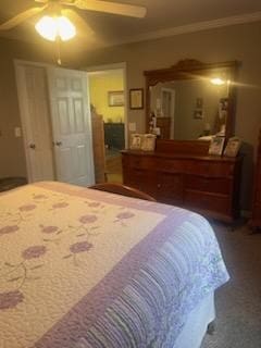 carpeted bedroom with ornamental molding and ceiling fan